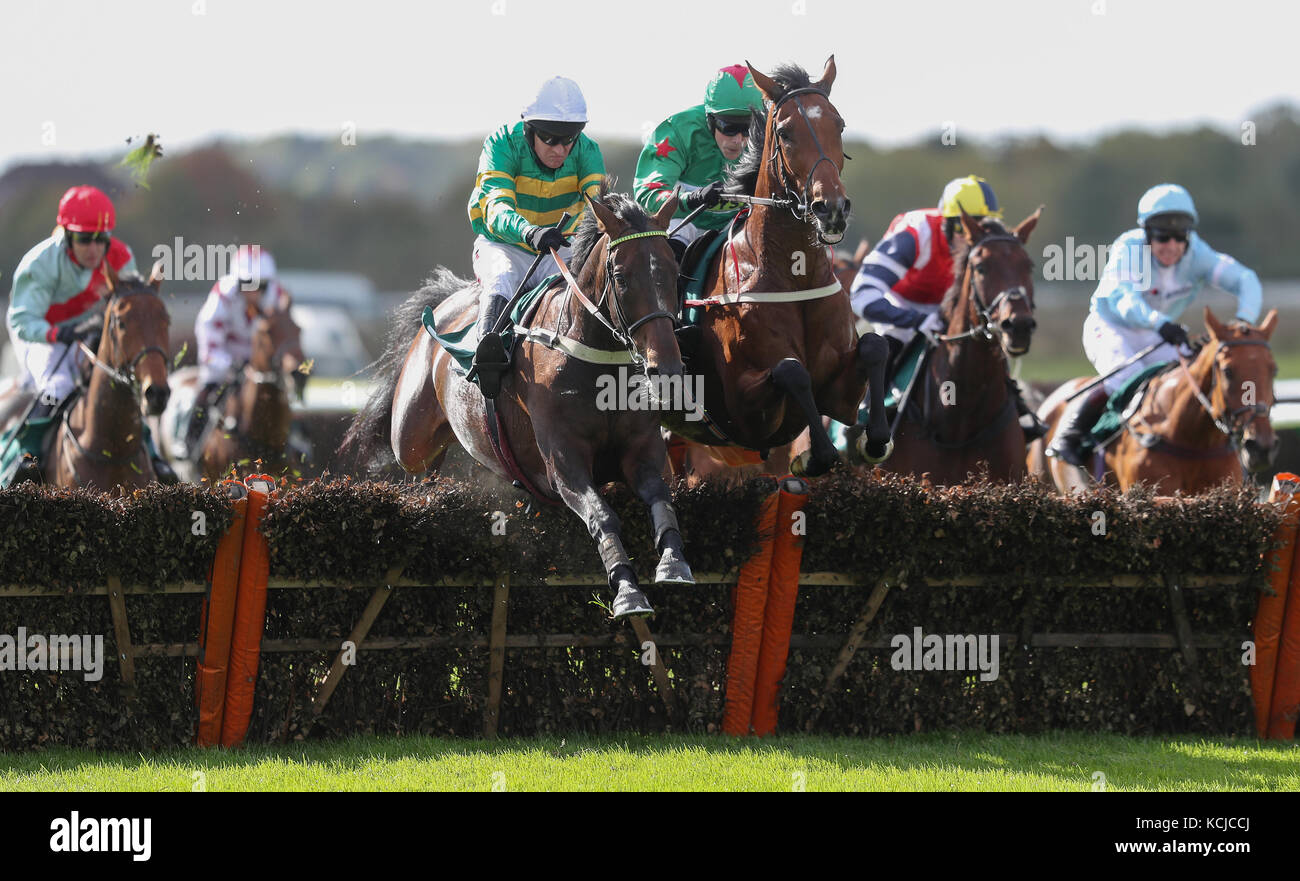 Eventual winner Herewego Herewego ridden by Barry Geraghty (left) jumps the last with Megabucks ridden by James Davies in the Old Fourpenny Shop 'National Hunt' Novices' Hurdle at Warwick Racecourse. Stock Photo