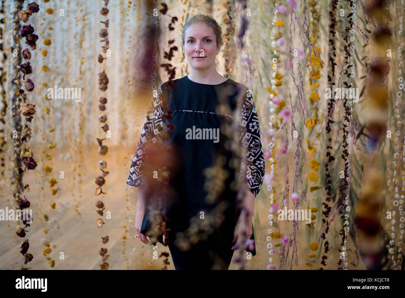 Artist Rebecca Louise Law with her new hanging installation 'Life in Death' featuring 375,000 flowers, at the Shirley Sherwood Gallery of Botanical Art, part of Artful Autumn at Kew Gardens in south west London. Stock Photo