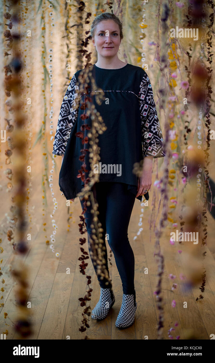 Artist Rebecca Louise Law with her new hanging installation 'Life in Death' featuring 375,000 flowers, at the Shirley Sherwood Gallery of Botanical Art, part of Artful Autumn at Kew Gardens in south west London. Stock Photo