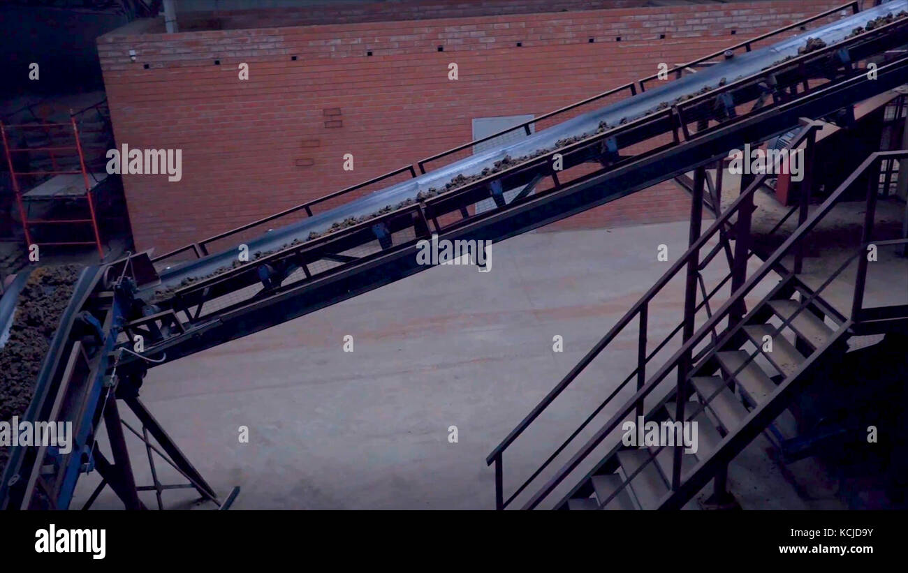 Industrial belt conveyor. Moving Raw Materials. Long conveyor belt