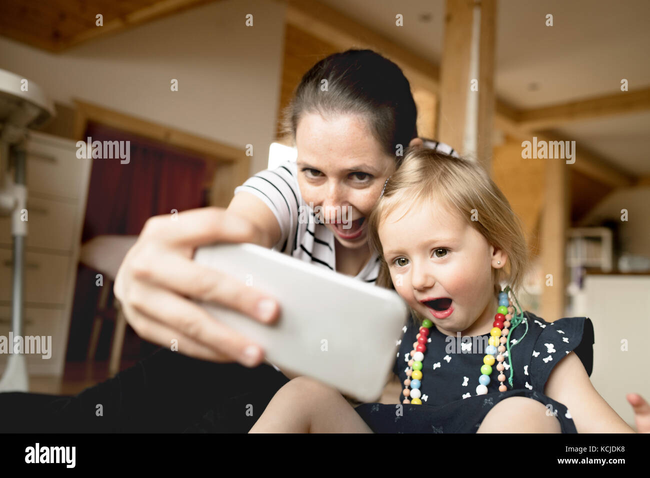 Beautiful mother and little daughter taking selfie with smartpho Stock Photo Alamy