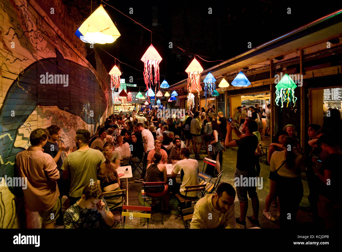 Typical night time scene in the Kuplung ruin bar pub in budapest with people drinking sitting standing talking .... Stock Photo