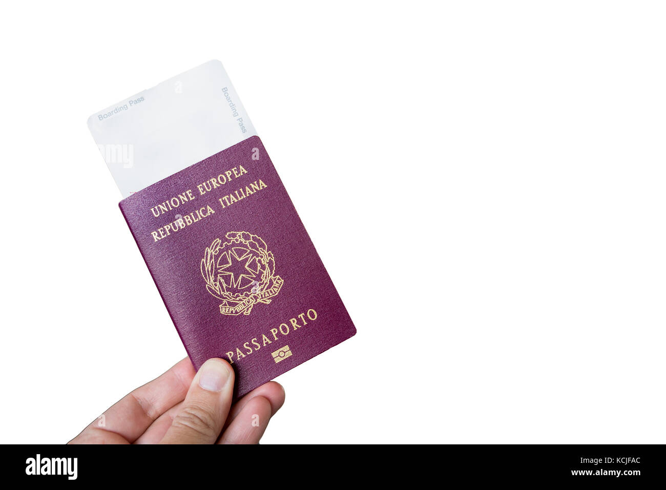 Hand holding an Italian passport with a boarding pass inside isolated over white. Stock Photo