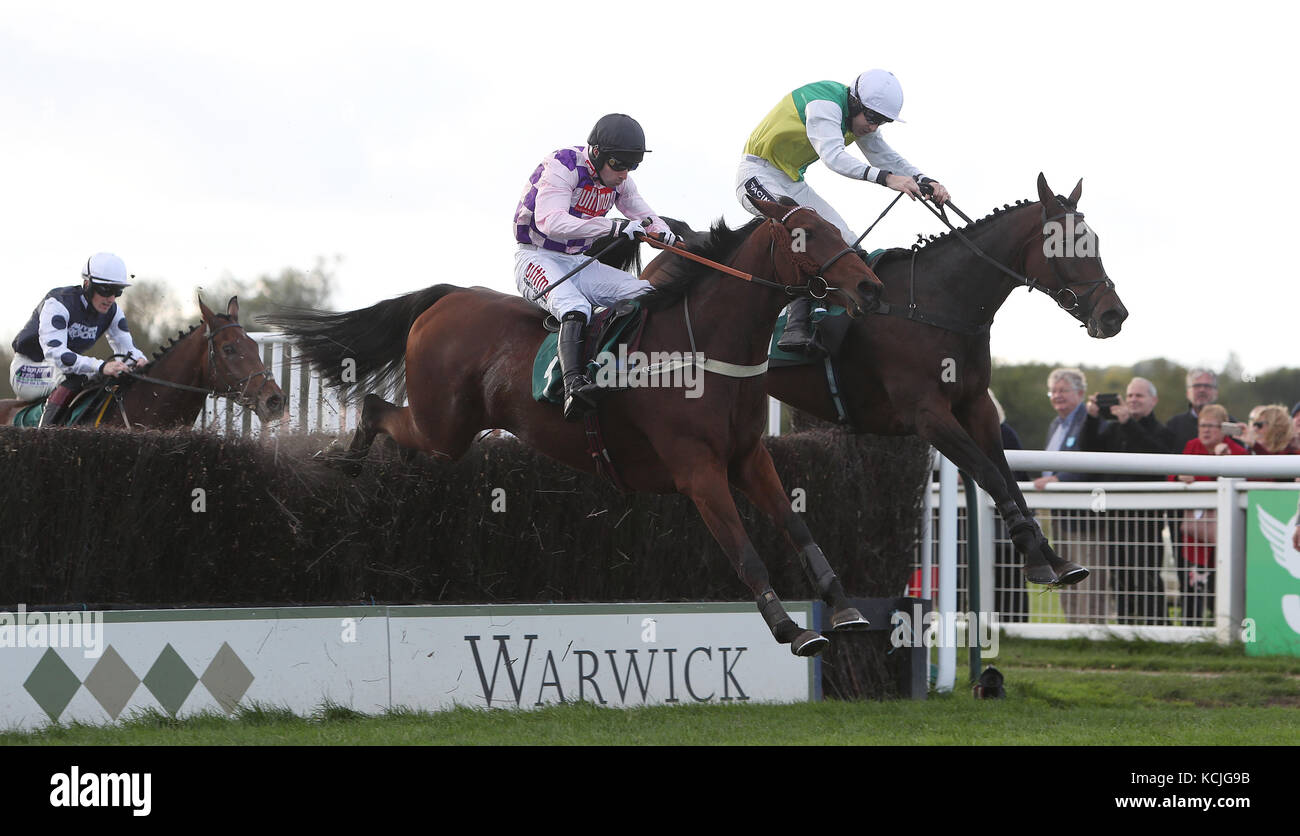 Eventual winner Beggars Cross ridden by Aidan Coleman (right) jumps the last with Sego Success ridden by Wayne Hutchinson in the Colliers International Business Rate Services Handicap Chase at Warwick Racecourse. Stock Photo