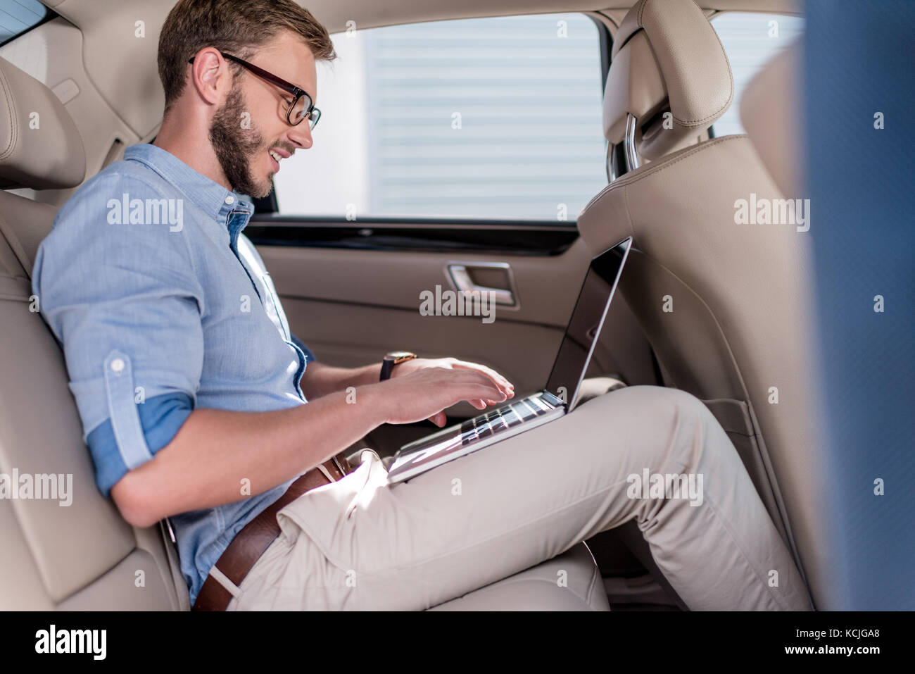 man using laptop in car Stock Photo Alamy