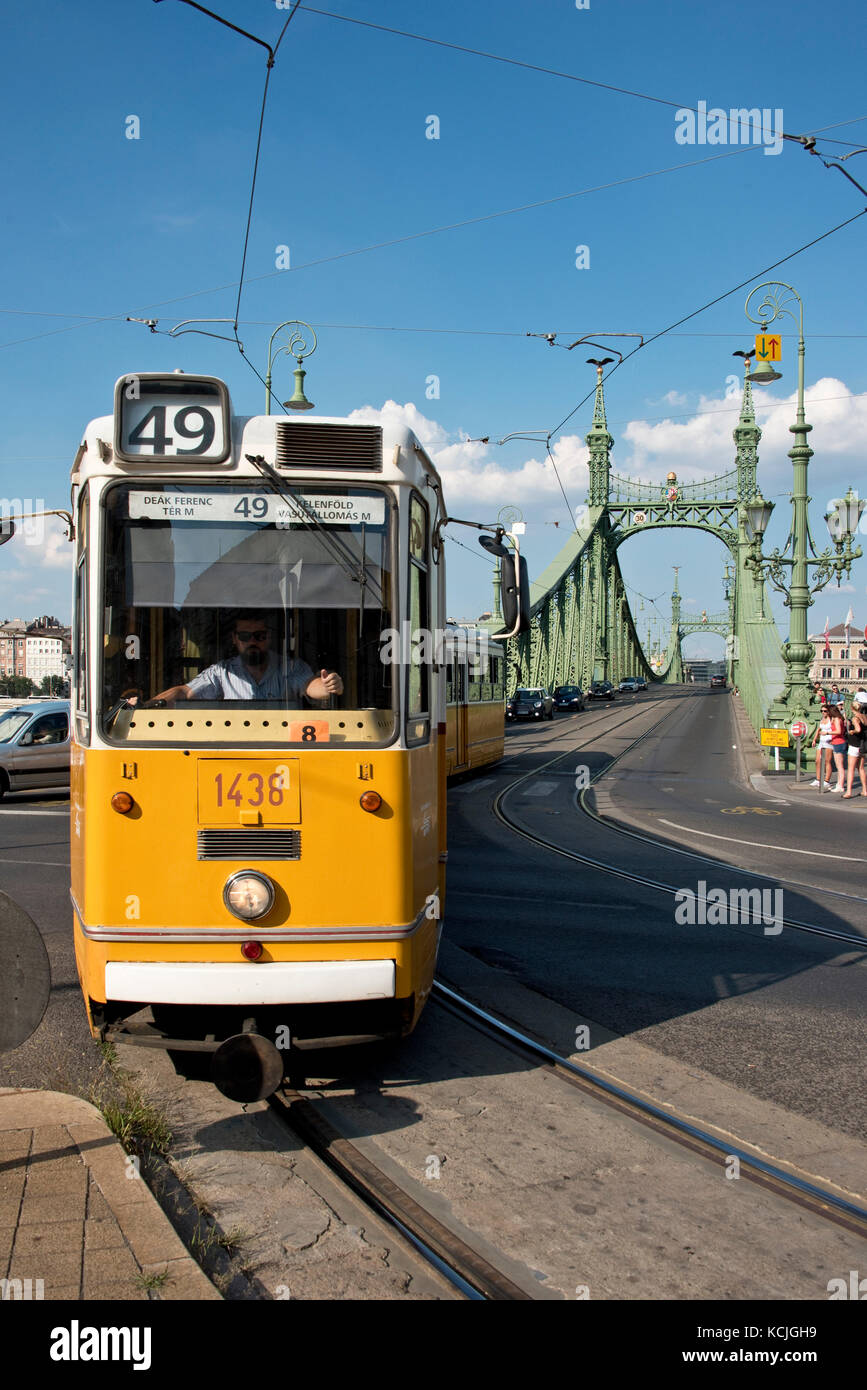 The Ganz CSMG tram in Budapest crossing the Liberty Bridge on a sunny day with blue sky. Stock Photo