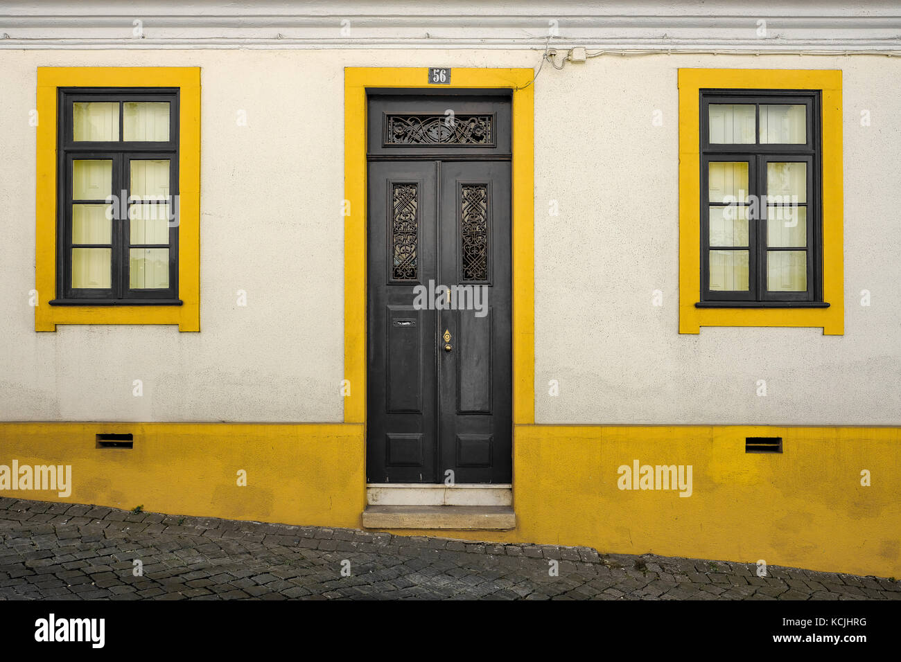 Traditional Portuguese residence in colonial style at the city center of aveiro, in graphic white ans yellow color Stock Photo
