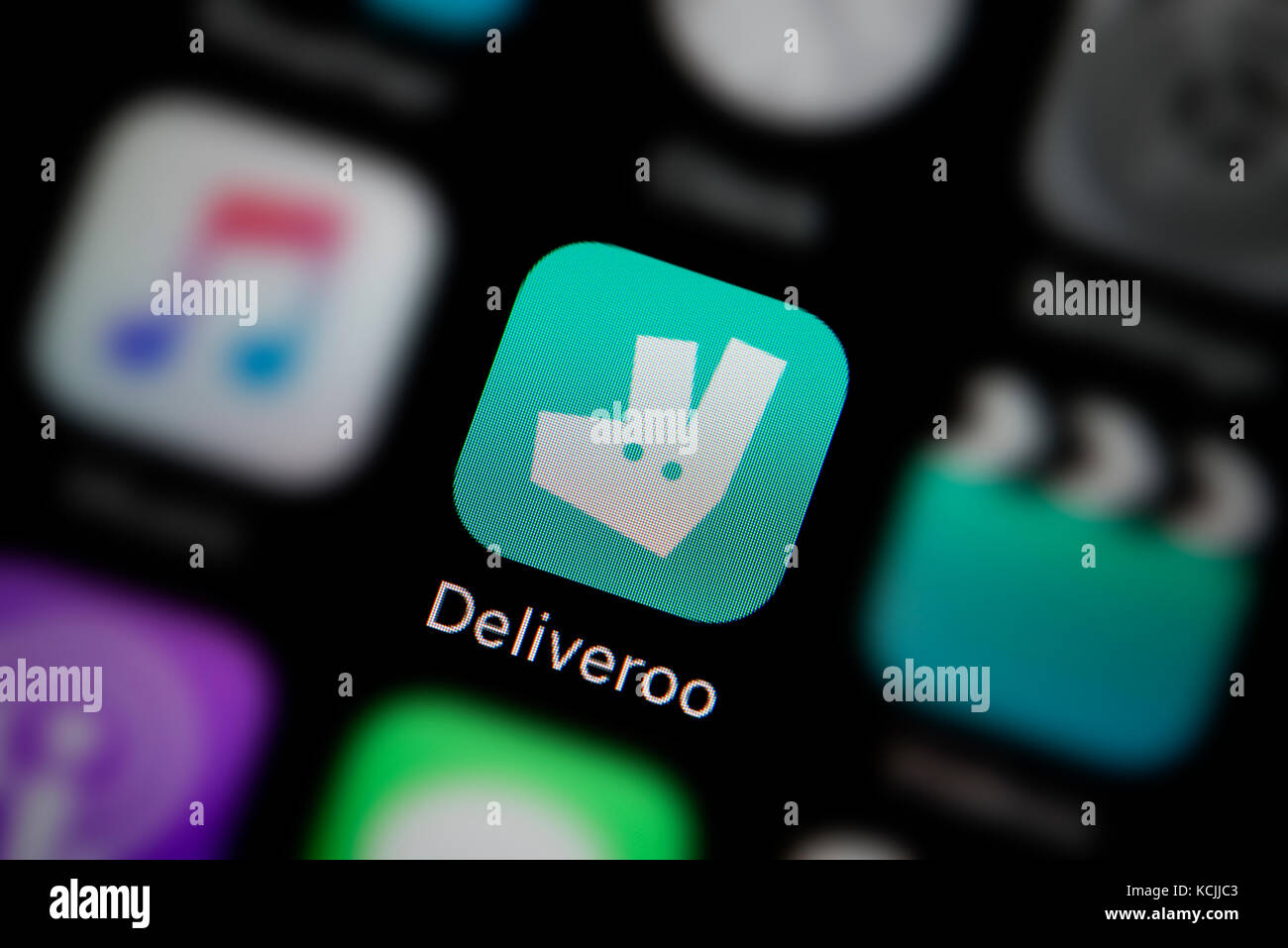 A close-up shot of the company logo representing the Deliveroo app icon, as seen on the screen of a smart phone (Editorial use only) Stock Photo