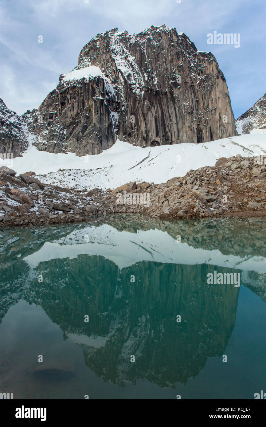 Snowpatch Spire reflected in a tarn in Bugaboo Provincial Park, Purcell Range, British Columbia, Canada. Stock Photo