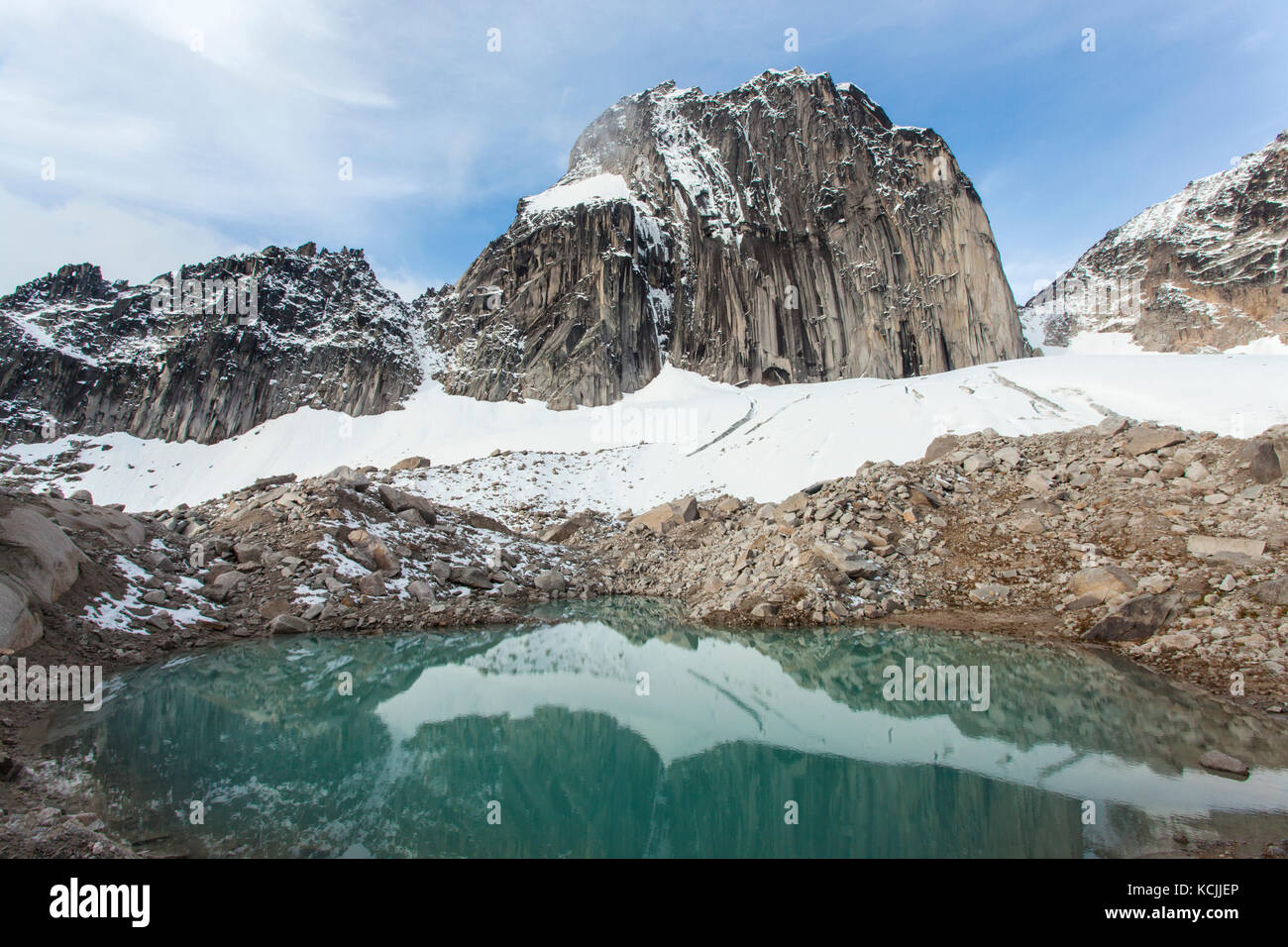 Snowpatch Spire above a tarn in Bugaboo Provincial Park, Purcell Range, British Columbia, Canada. Stock Photo