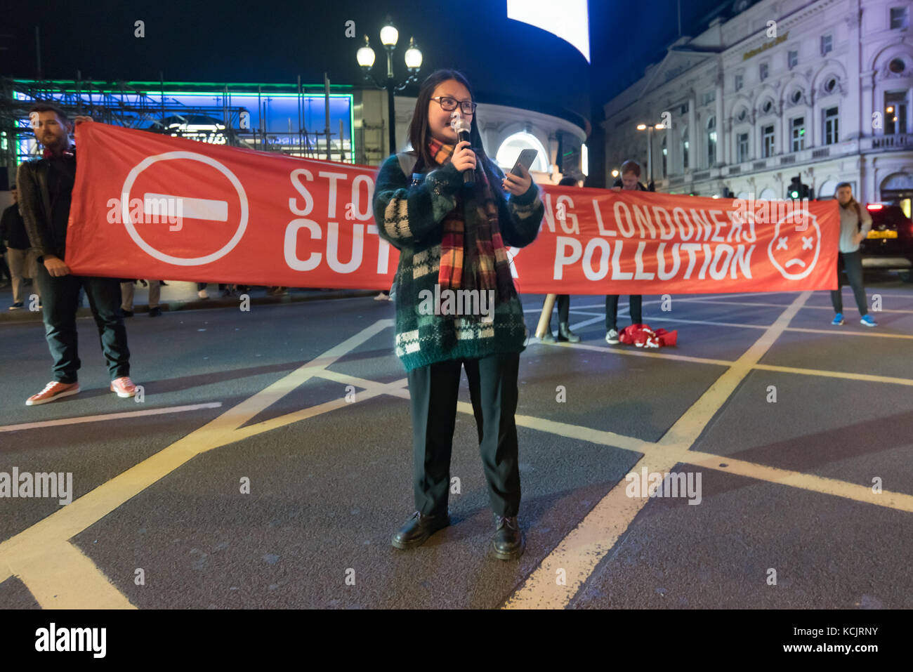 London, UK. 5th October 2017. A campaigner speaks about the thousands of premature deaths in London each year from NO2 and particulates from traffic fumes, which also cause much chronic suffering from lung diseases and breathing problems. 'Stop Killing Londoners' had briefly blocked the road at Piccadilly Circus, one of London's busiest road junctions in their latest protest against air pollution, which comes mainly from traffic. Credit: Peter Marshall/Alamy Live News Stock Photo