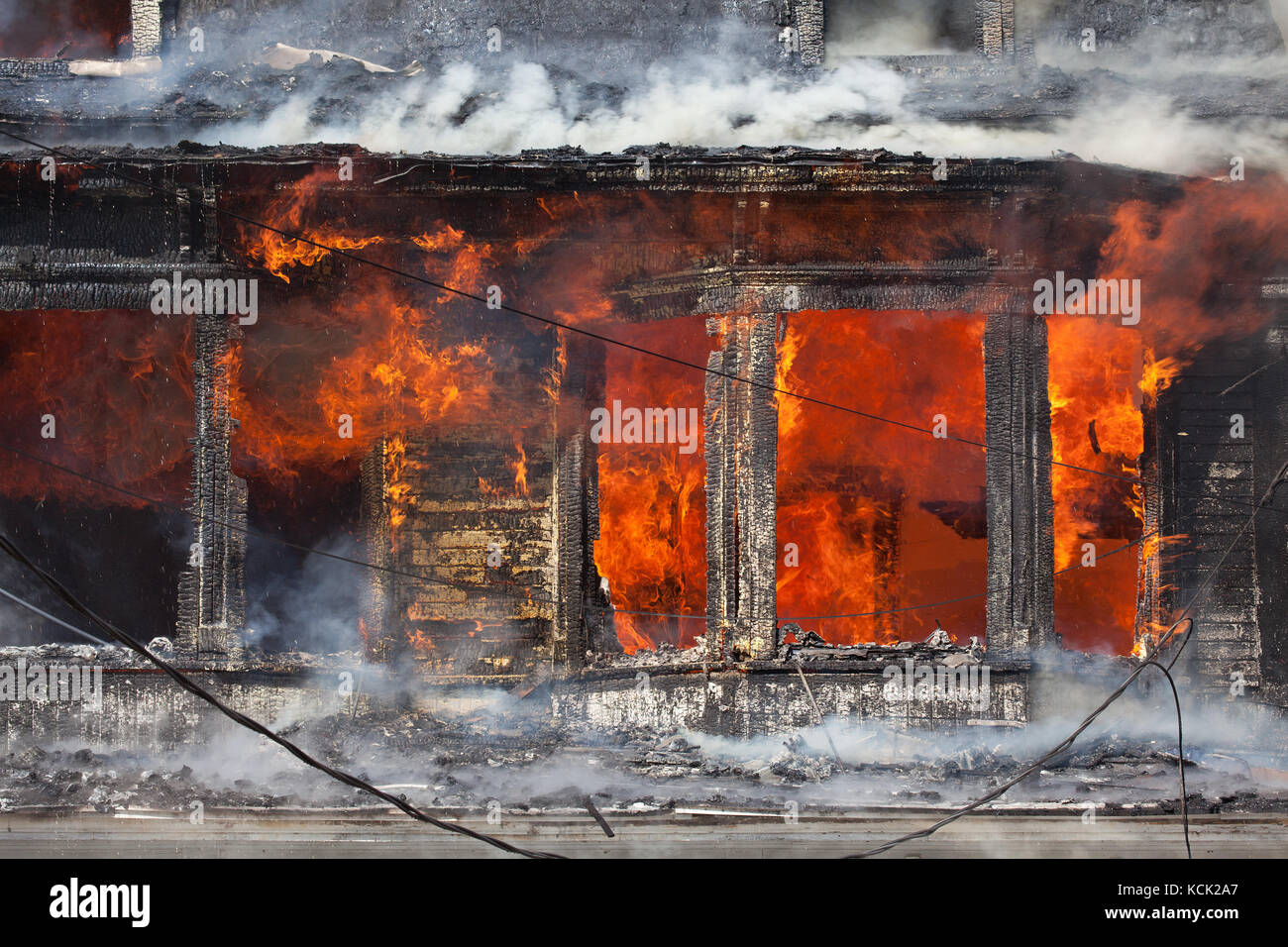 Residential home engulfed in flames. Stock Photo