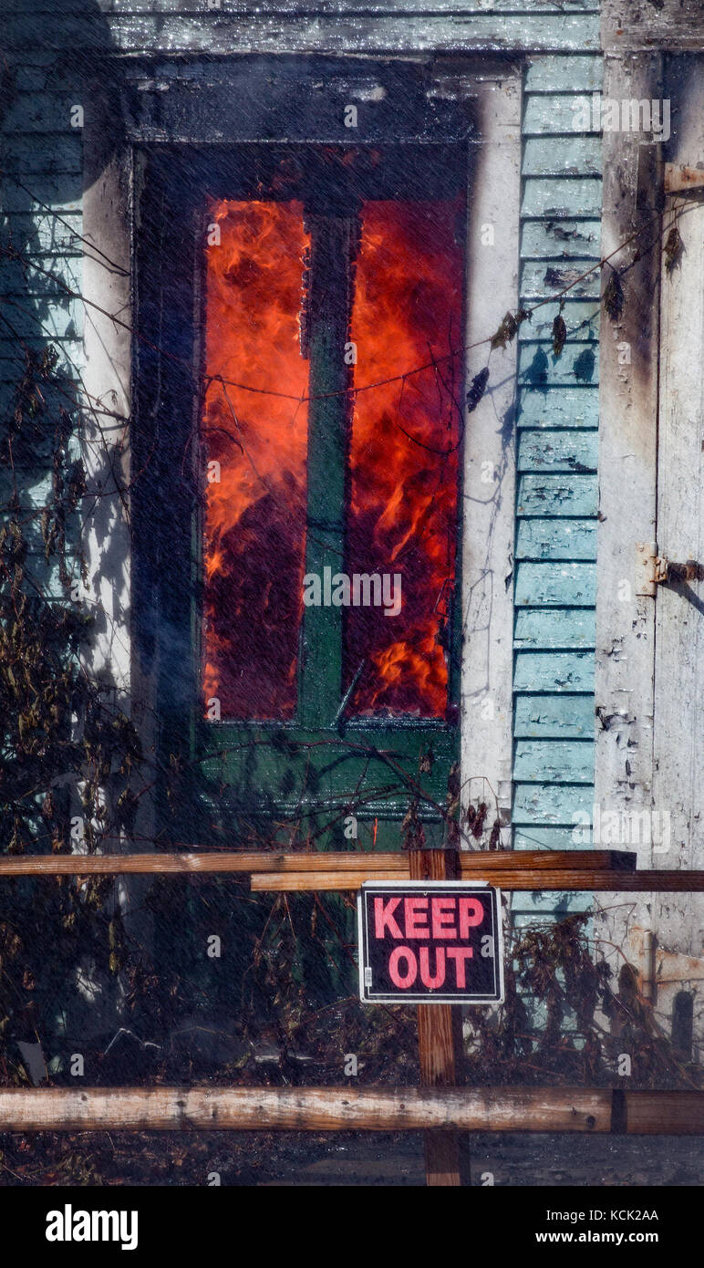 Residential home engulfed in flames. Stock Photo