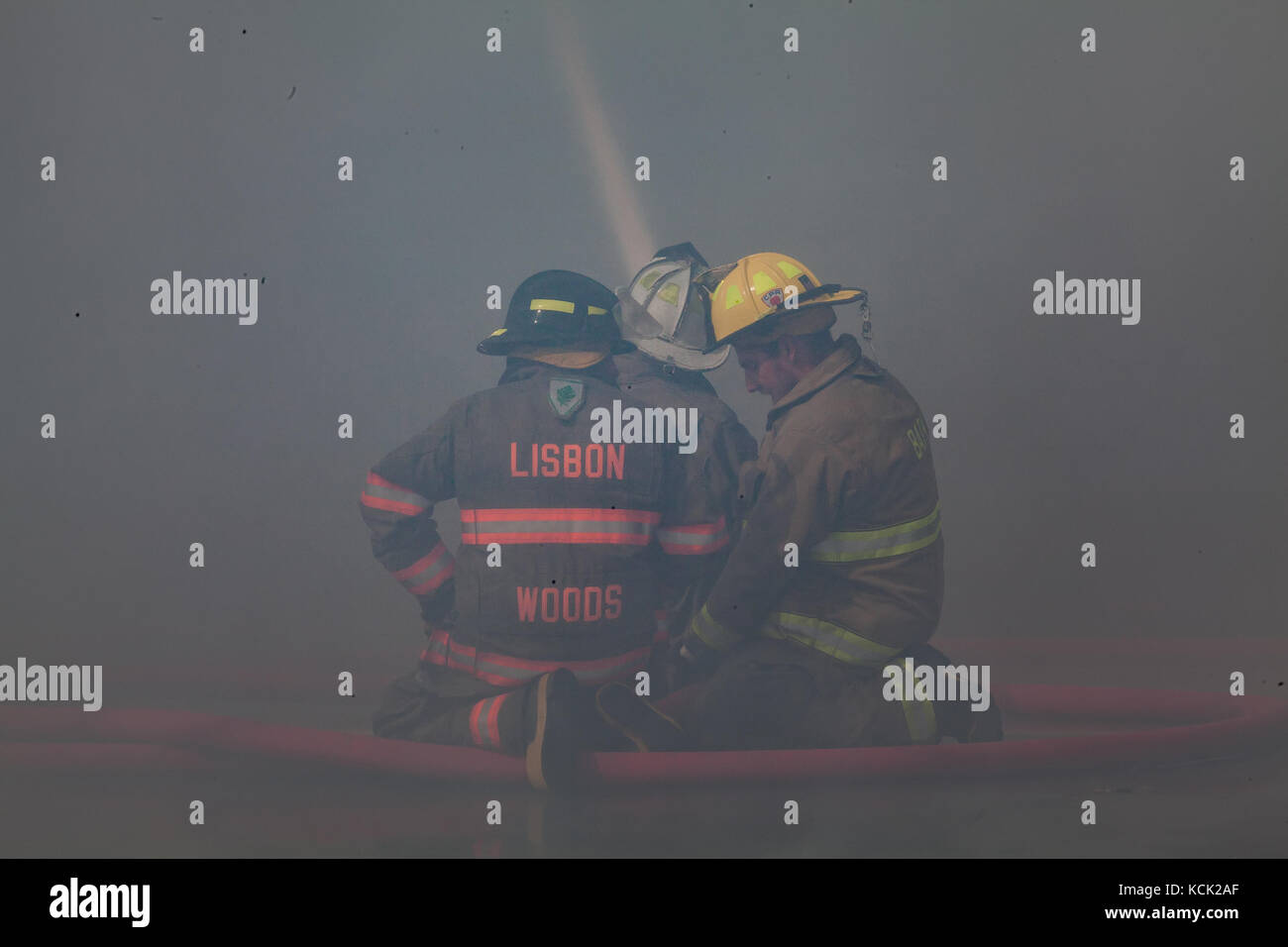Lisbon, NH, USA. 5th Oct. 2017. Firefighters endure heat and smoke as they battle a major house fire of unknown origin in Lisbon, NH, USA. Credit: Art Phaneuf/Alamy Live News Stock Photo