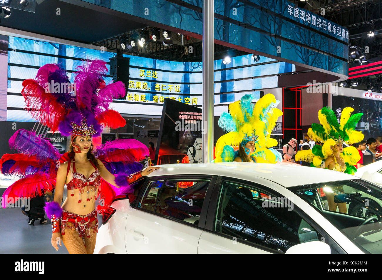Models in carnaval outifts posing at 2017 Shenzhen Auto Show. Stock Photo
