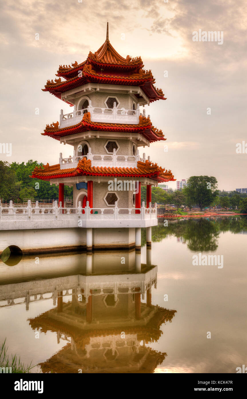 Sunset over Pagoda on a pond at Chinese Garden, a free public park in Singapore. The garden is modeled after the Chinese imperial style of architectur Stock Photo