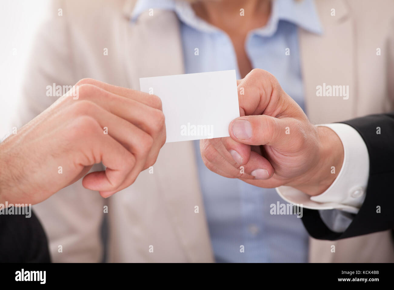 Two Businessman Exchanging Visiting Card In front Of Colleges Stock Photo