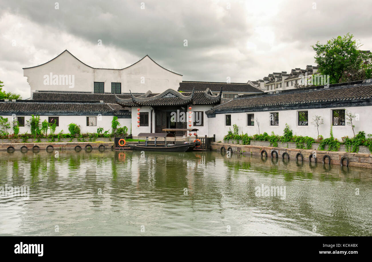 Chinese style buildings and tourist boats on the water canals of Xitang town in Jiashan county in Zhejiang province China. Stock Photo