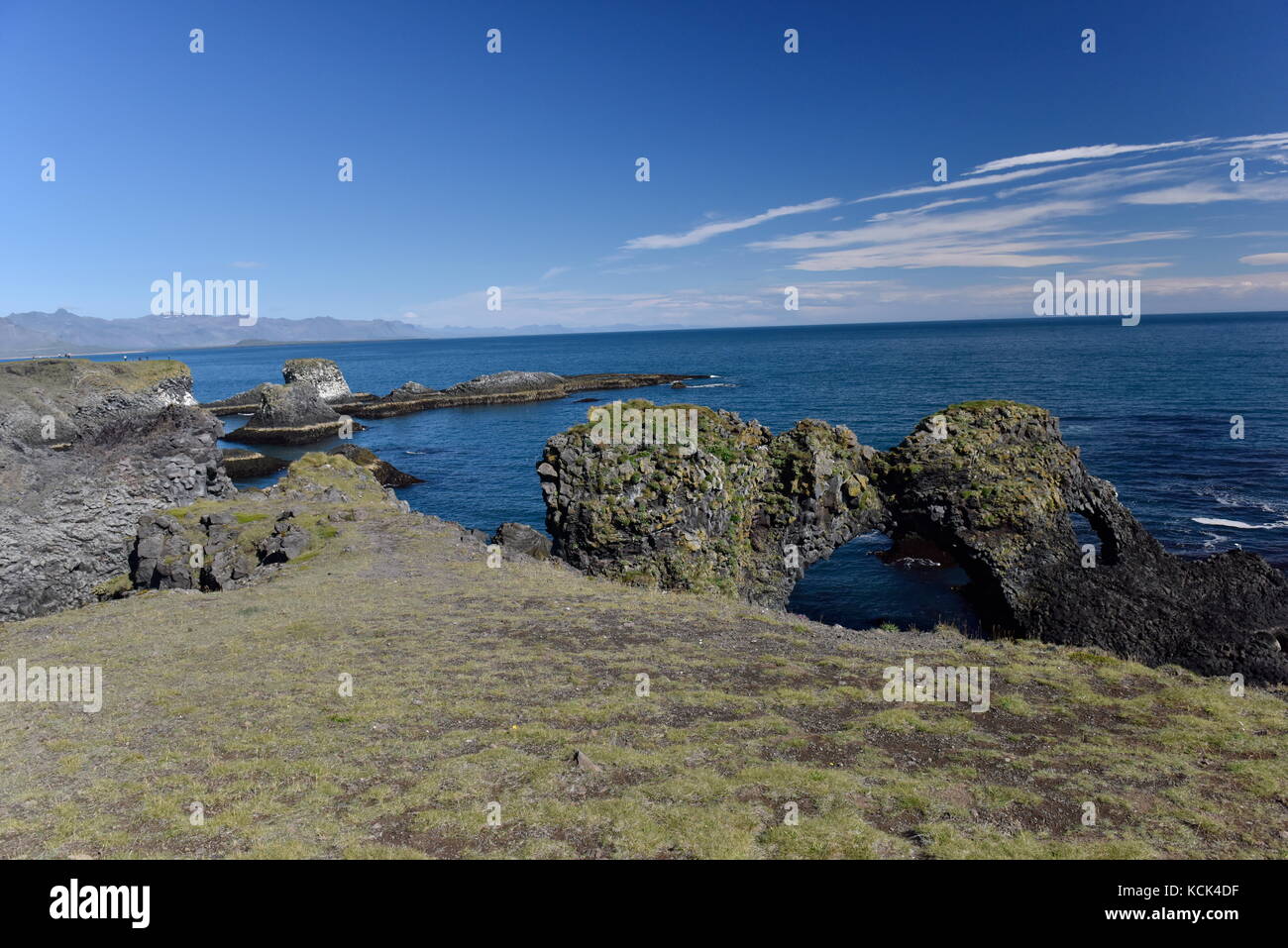 Shoreline and cliffs of basalt rock at Arnarstapi nature reserve seen ...