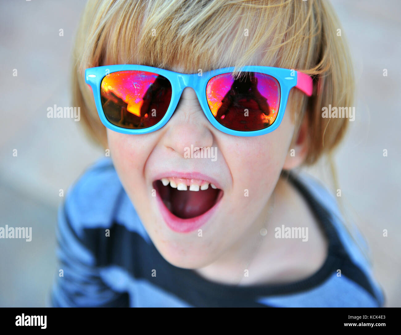 Portrait of a little boy wearing blue sunglasses Stock Photo Alamy