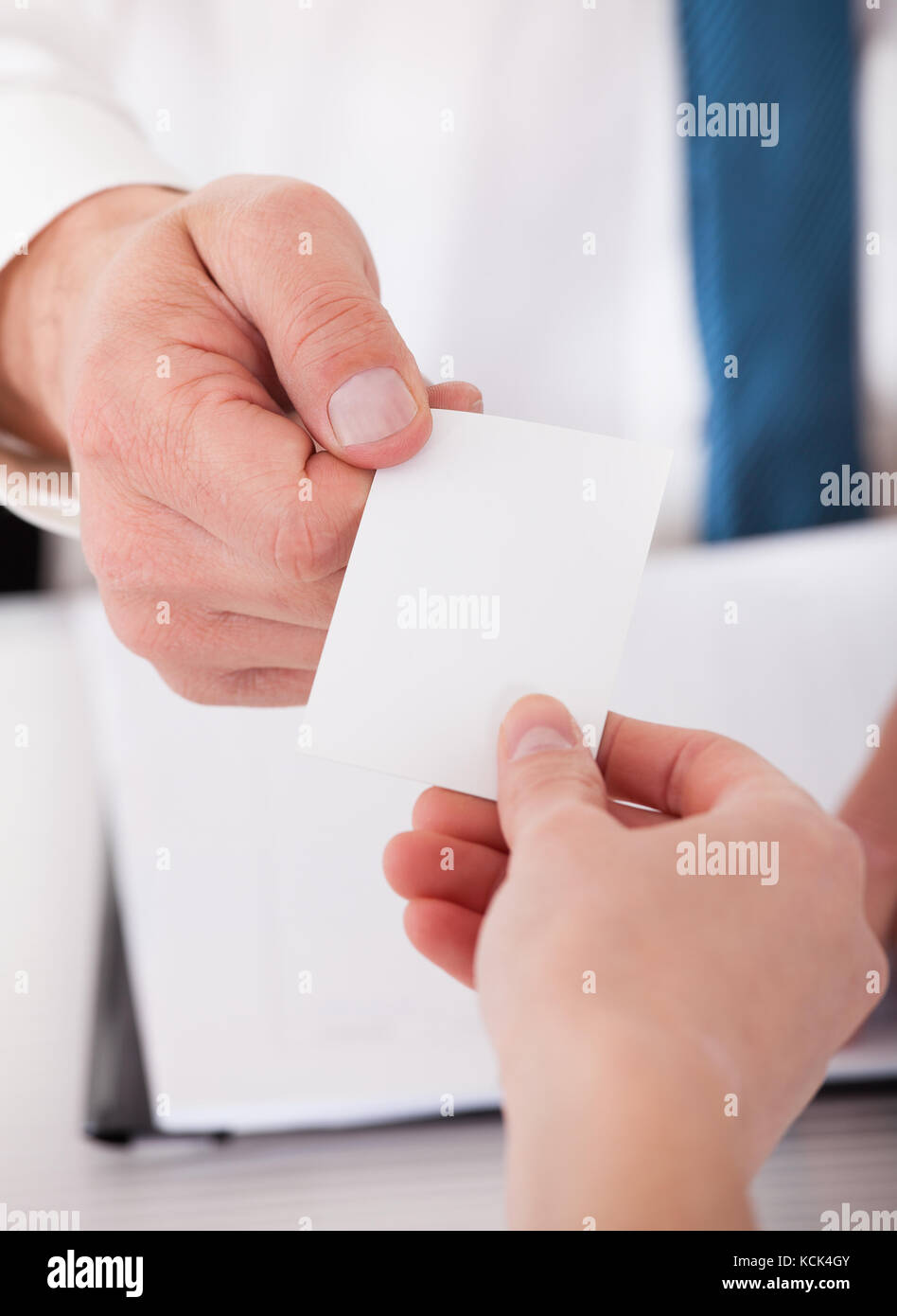 Two Business People Exchanging Card In Office Stock Photo Alamy