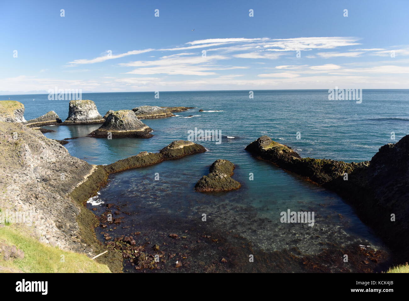 Shoreline and cliffs of basalt rock at Arnarstapi nature reserve seen ...