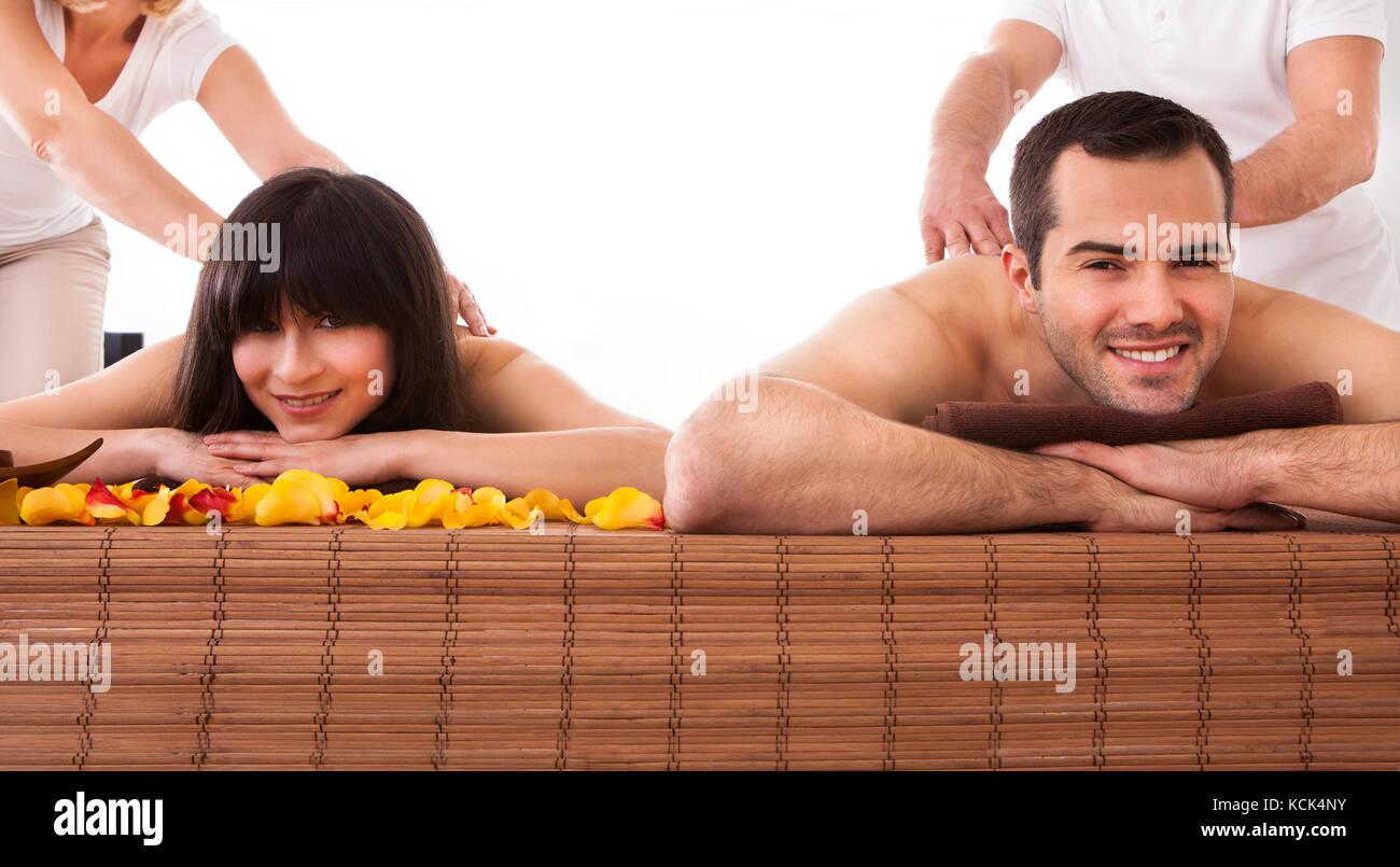 Beautiful Young Couple Enjoying Massage In Spa Centre Stock Photo