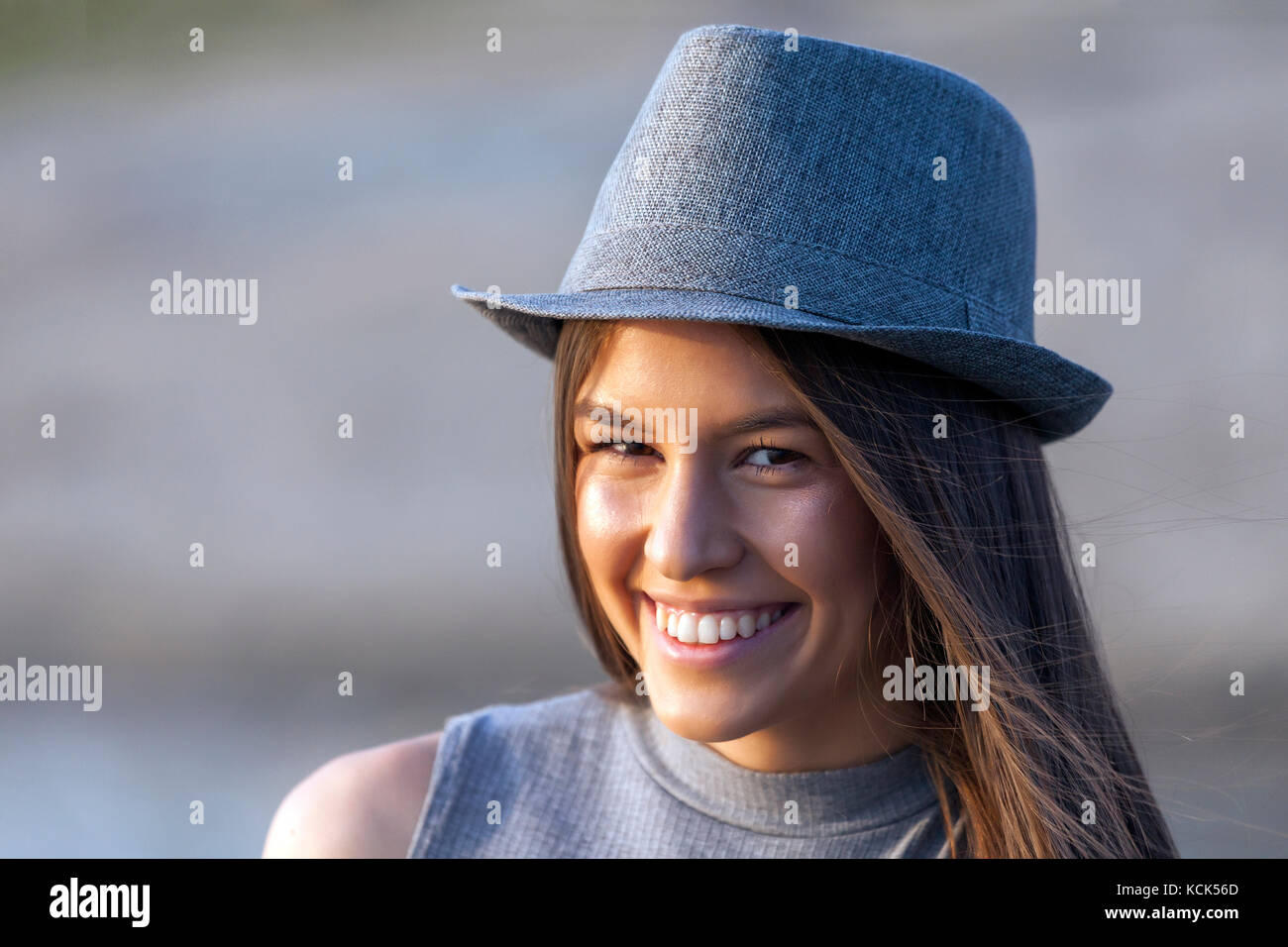 Close up portrait of happy smiling young girl with a hat outdoors.Copy ...