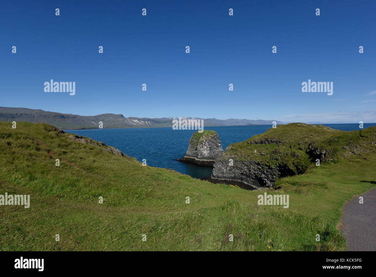 Shoreline and cliffs of basalt rock at Arnarstapi nature reserve seen ...