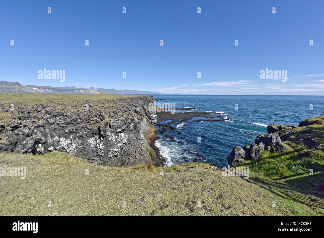 Shoreline and cliffs of basalt rock at Arnarstapi nature reserve seen ...