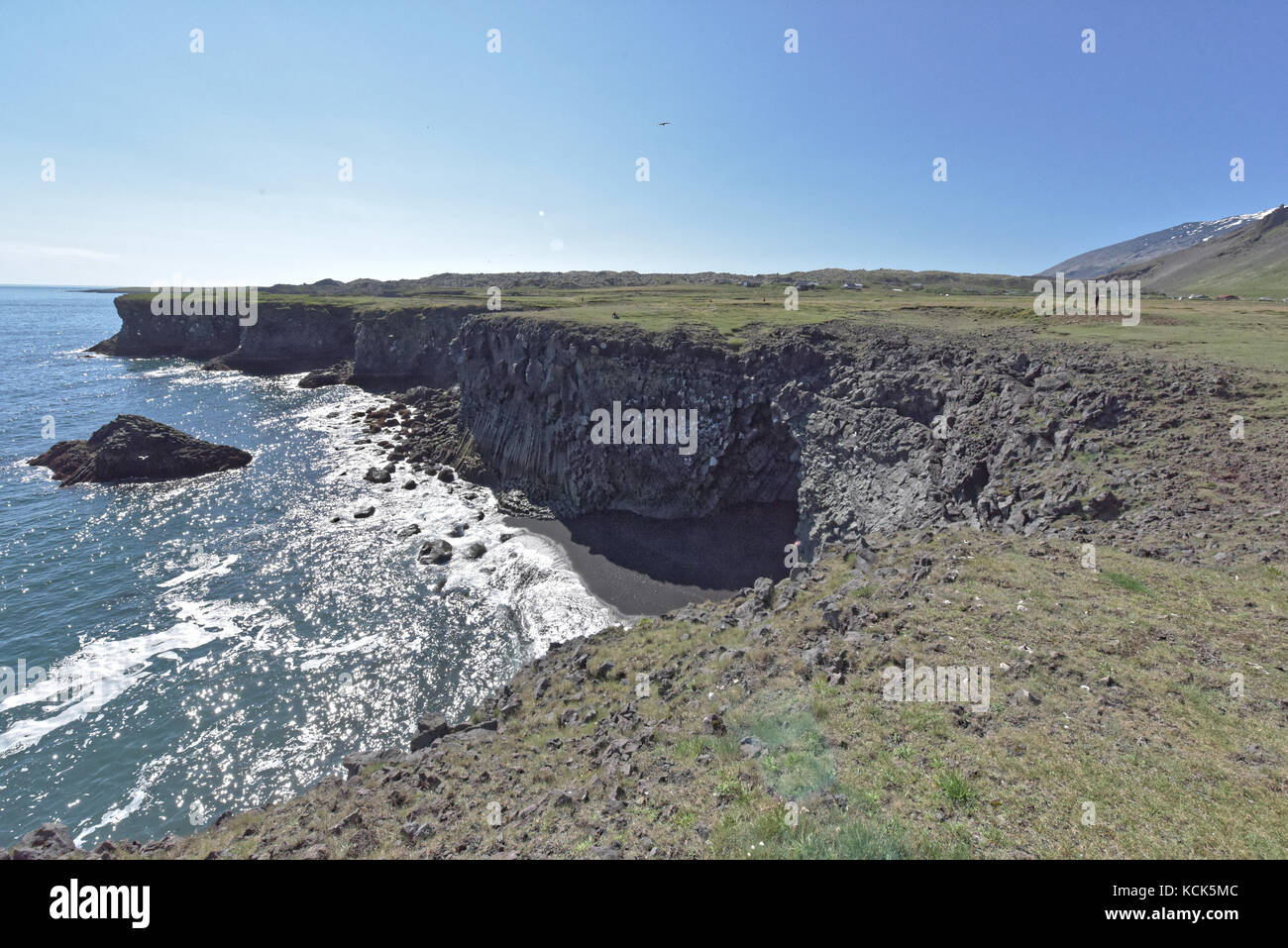Shoreline and cliffs of basalt rock at Arnarstapi nature reserve seen ...