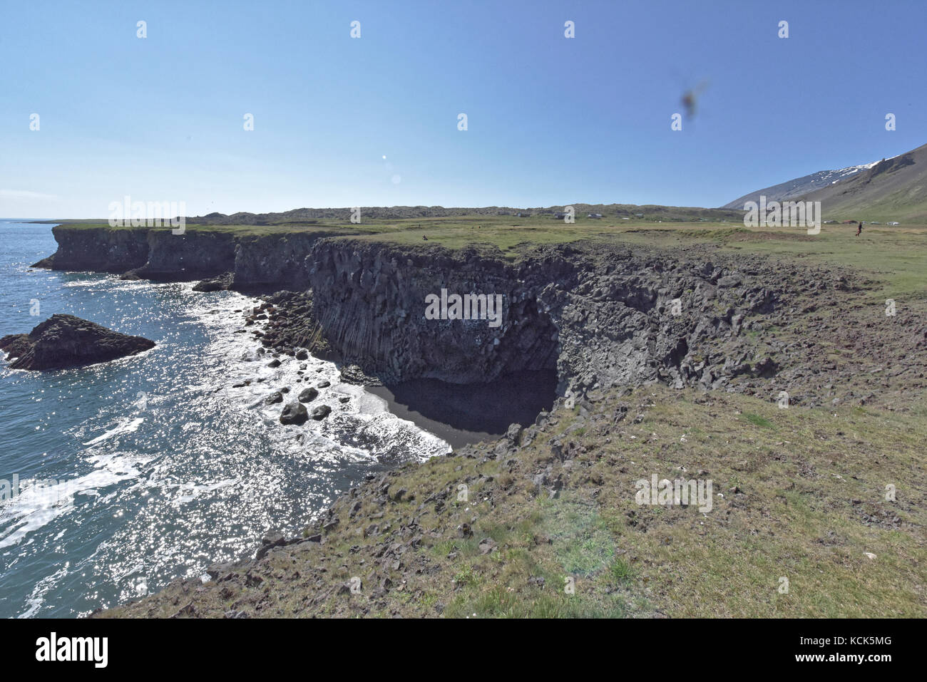 Shoreline and cliffs of basalt rock at Arnarstapi nature reserve seen ...