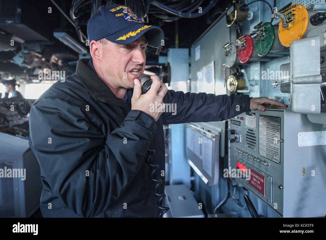 U.S. Navy Arleigh Burke-class guided-missile destroyer USS James E. Williams Commanding Officer Allen Siegrist speaks to the crew through a radio as the ship leaves port July 9, 2017 in Reykjavik, Iceland.  (photo by Colbey Livingston via Planetpix) Stock Photo