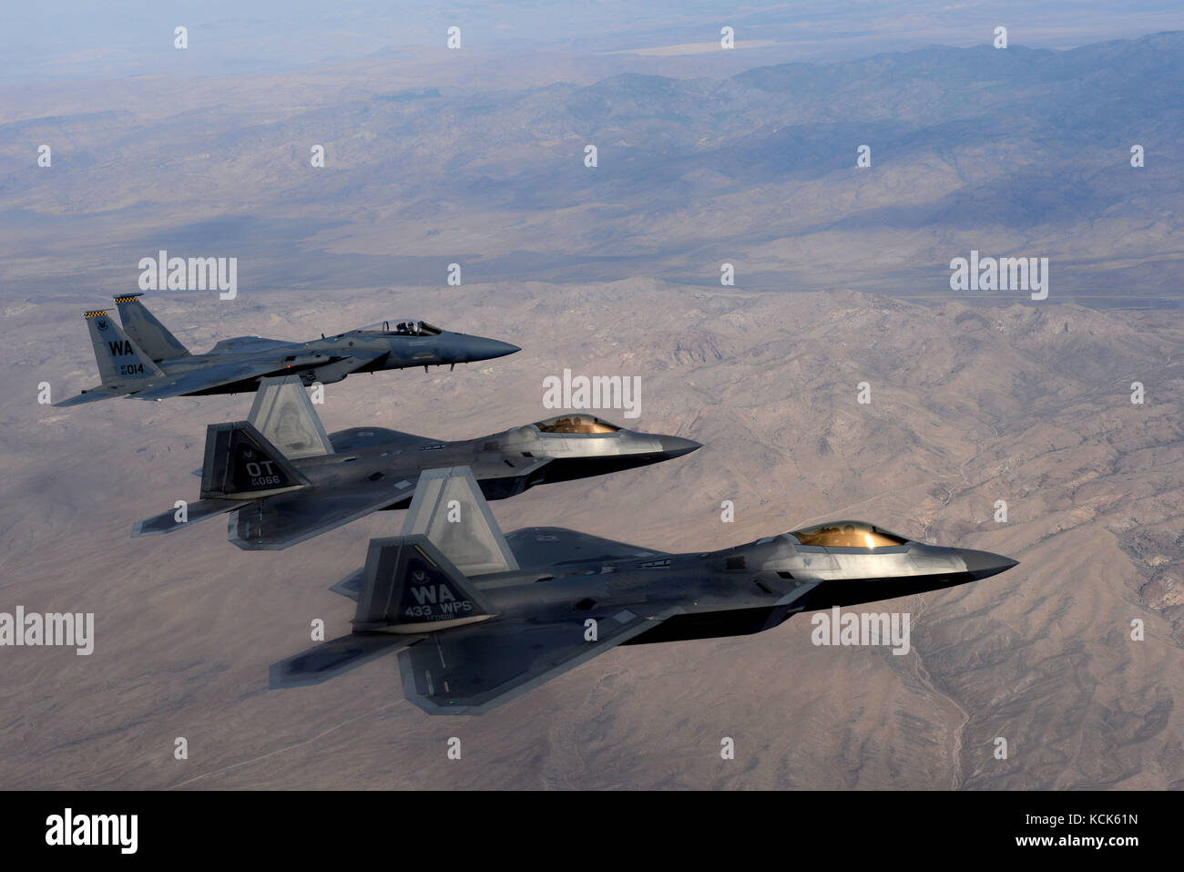 U.S. Air Force F-22 Raptor and F-15 Eagle stealth tactical fighter aircraft fly in formation over the Nellis Air Force Base Nevada Test and Training Range July 10, 2017 near Las Vegas, Nevada.  (photo by Daryn Murphy via Planetpix) Stock Photo