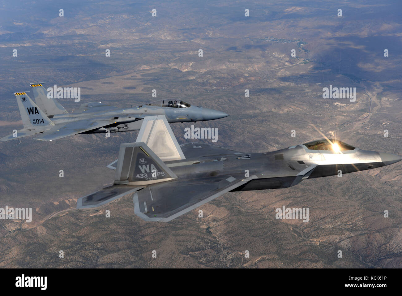 A U.S. Air Force F-22 Raptor and an F-15 Eagle stealth tactical fighter aircraft fly in formation over the Nellis Air Force Base Nevada Test and Training Range July 10, 2017 near Las Vegas, Nevada.  (photo by Daryn Murphy via Planetpix) Stock Photo