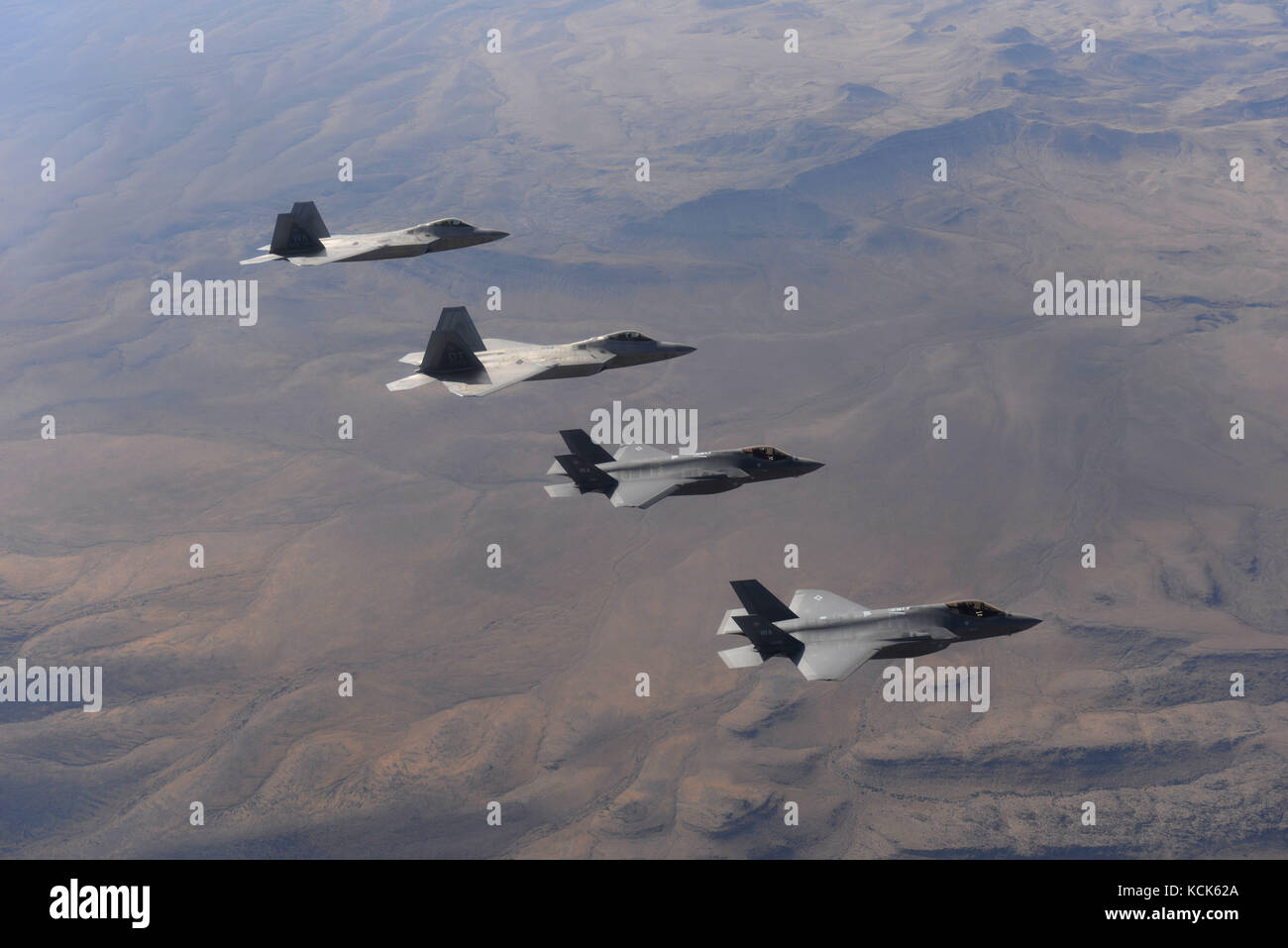 U.S. Air Force F-35 Lightning II and F-22 Raptor stealth tactical fighter aircraft fly in formation over the Nellis Air Force Base Nevada Test and Training Range July 10, 2017 near Las Vegas, Nevada.  (photo by Daryn Murphy via Planetpix) Stock Photo