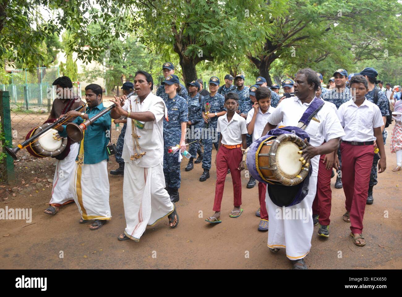 Indian musicians lead a procession of U.S. Navy sailors upon their arrival to the Young Mens Christian Association Secondary School during Exercise Malabar July 12, 2017 in Chennai, India.  (photo by MCS2 Erickson B Magno  via Planetpix) Stock Photo