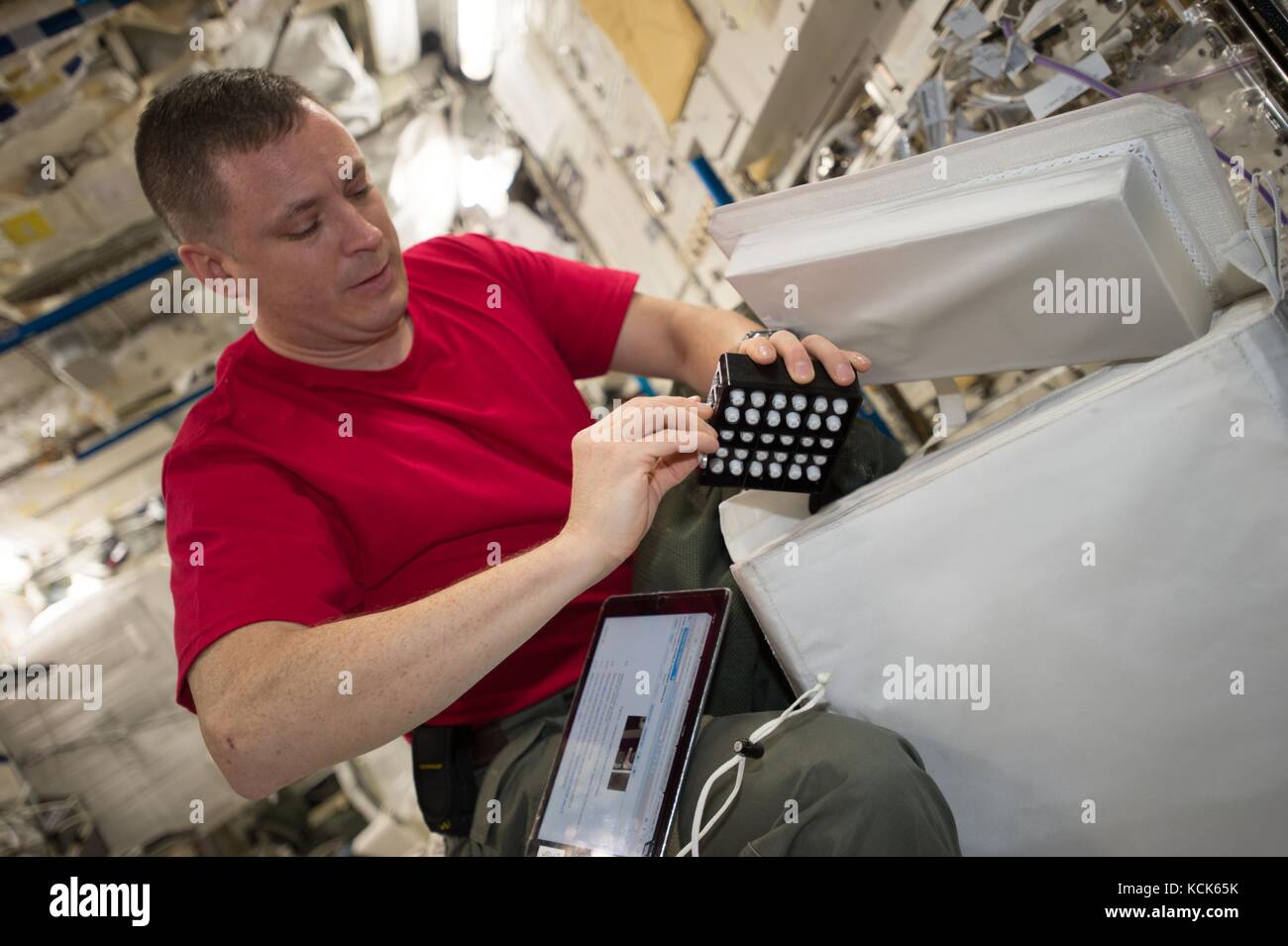 NASA International Space Station Expedition 51 prime crew member American astronaut Jack Fischer works on the Design of Accelerated Reactivators experiment in the Japanese Experiment Module June 6, 2017 in Earth orbit.   (photo by NASA Photo  via Planetpix) Stock Photo