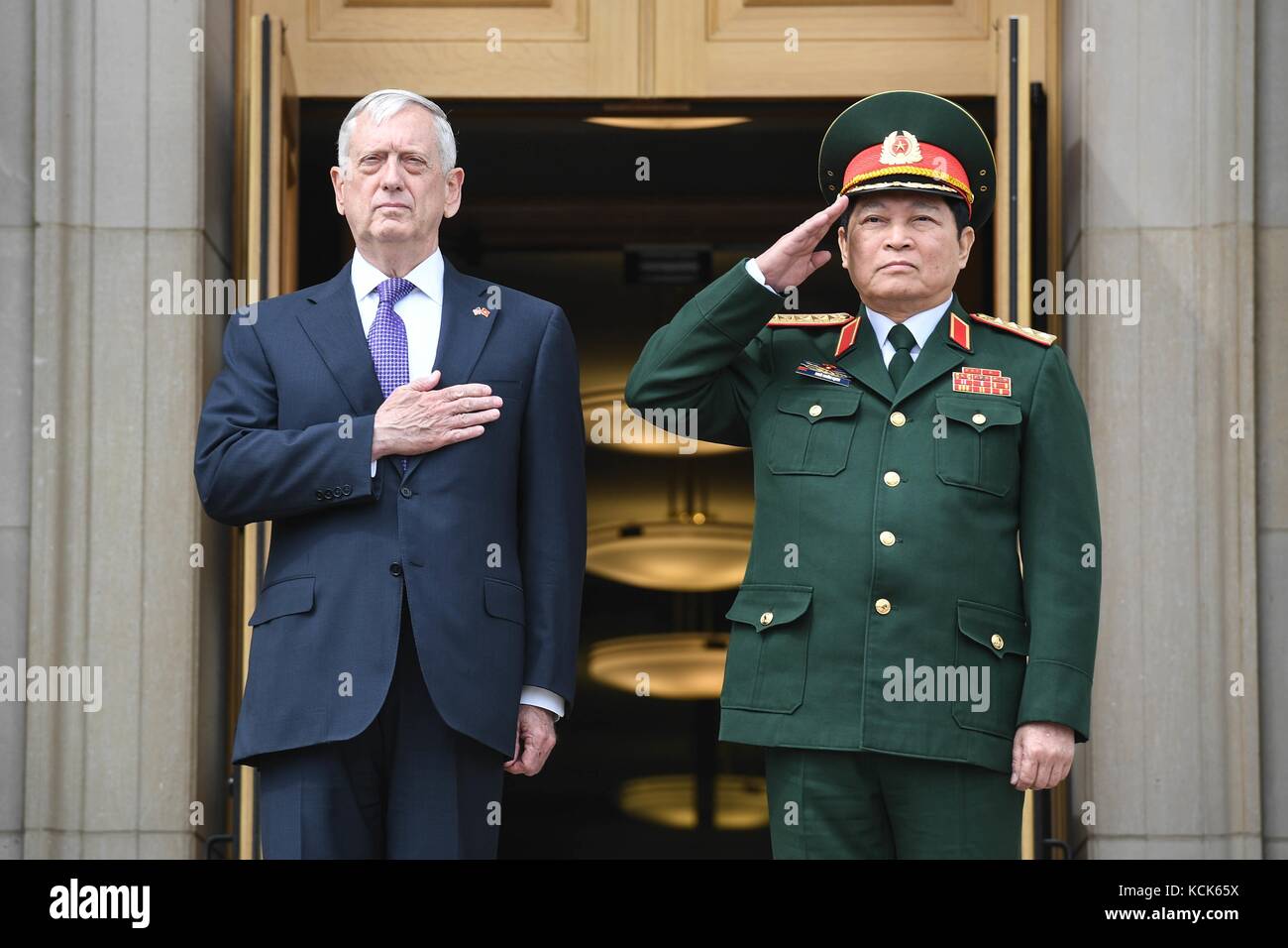 U.S. Defense Secretary James Mattis (left) and Vietnamese National Defense Minister Ngo Xuan Lich render honors during the National Anthem at the Pentagon August 8, 2017 in Arlington, Virginia.  (photo by Tammy Nooner  via Planetpix) Stock Photo