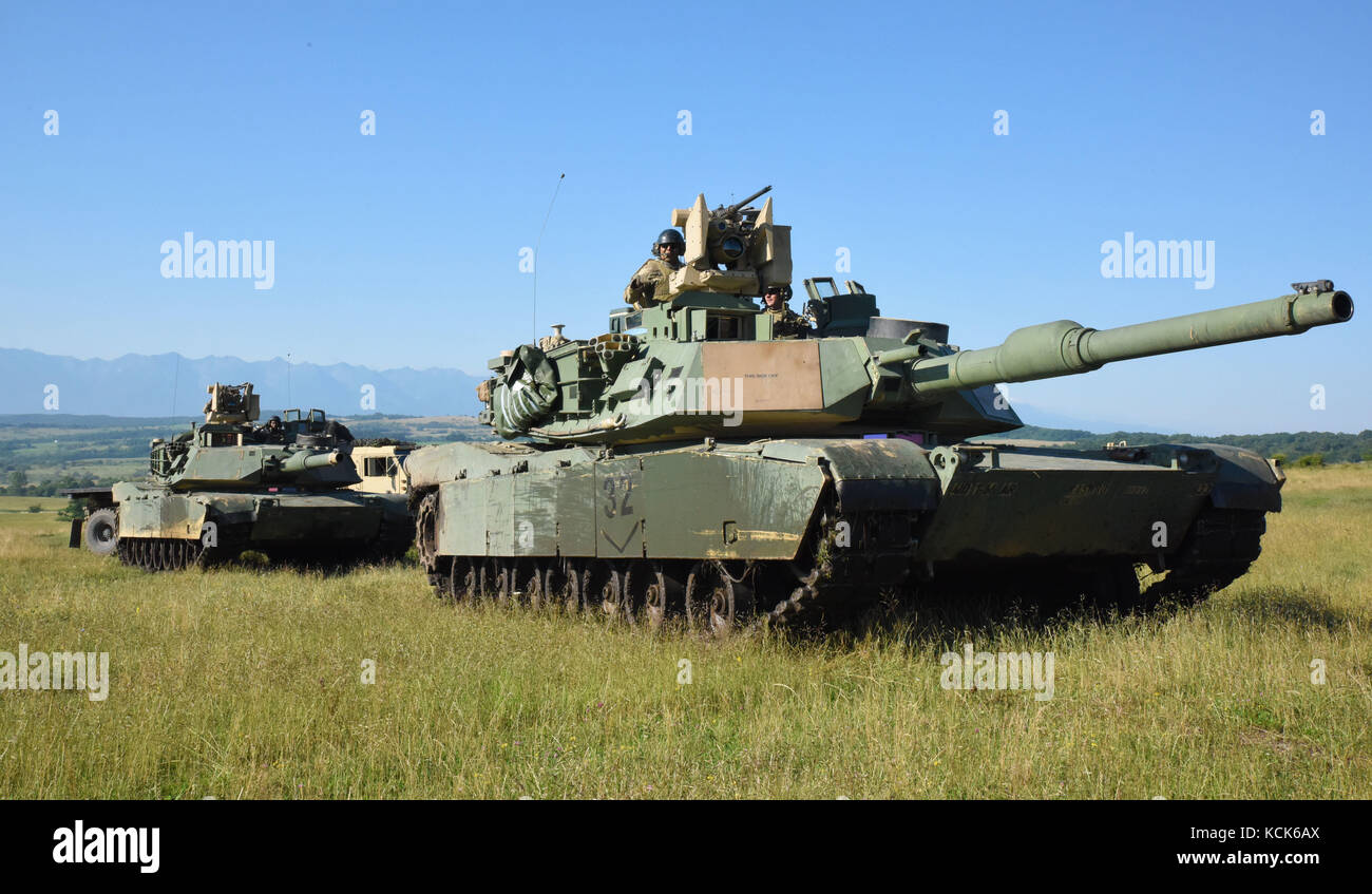 U.S. Army soldiers set up their M1 Abrams battle tanks in preparation for exercise Getica Saber July 10, 2017 in Cincu, Romania.  (photo by Kelsey M. Little via Planetpix) Stock Photo