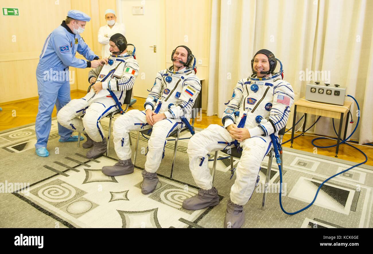 NASA International Space Station Expedition 52 prime crew members (L-R) Italian astronaut Paolo Nespoli of the European Space Agency, Russian cosmonaut Sergey Ryazanskiy of Roscosmos, and American astronaut Randy Bresnik are helped into their Sokol spacesuits in preparation for the Soyuz MS-05 launch at the Baikonur Cosmodrome July 28, 2017 in Baikonur, Kazakhstan.  (photo by Andrey Shelepin  via Planetpix) Stock Photo