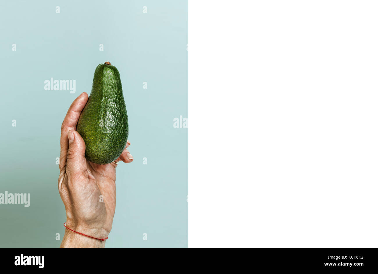 Style minimalism. Ripe avocado in a woman's hand Stock Photo - Alamy