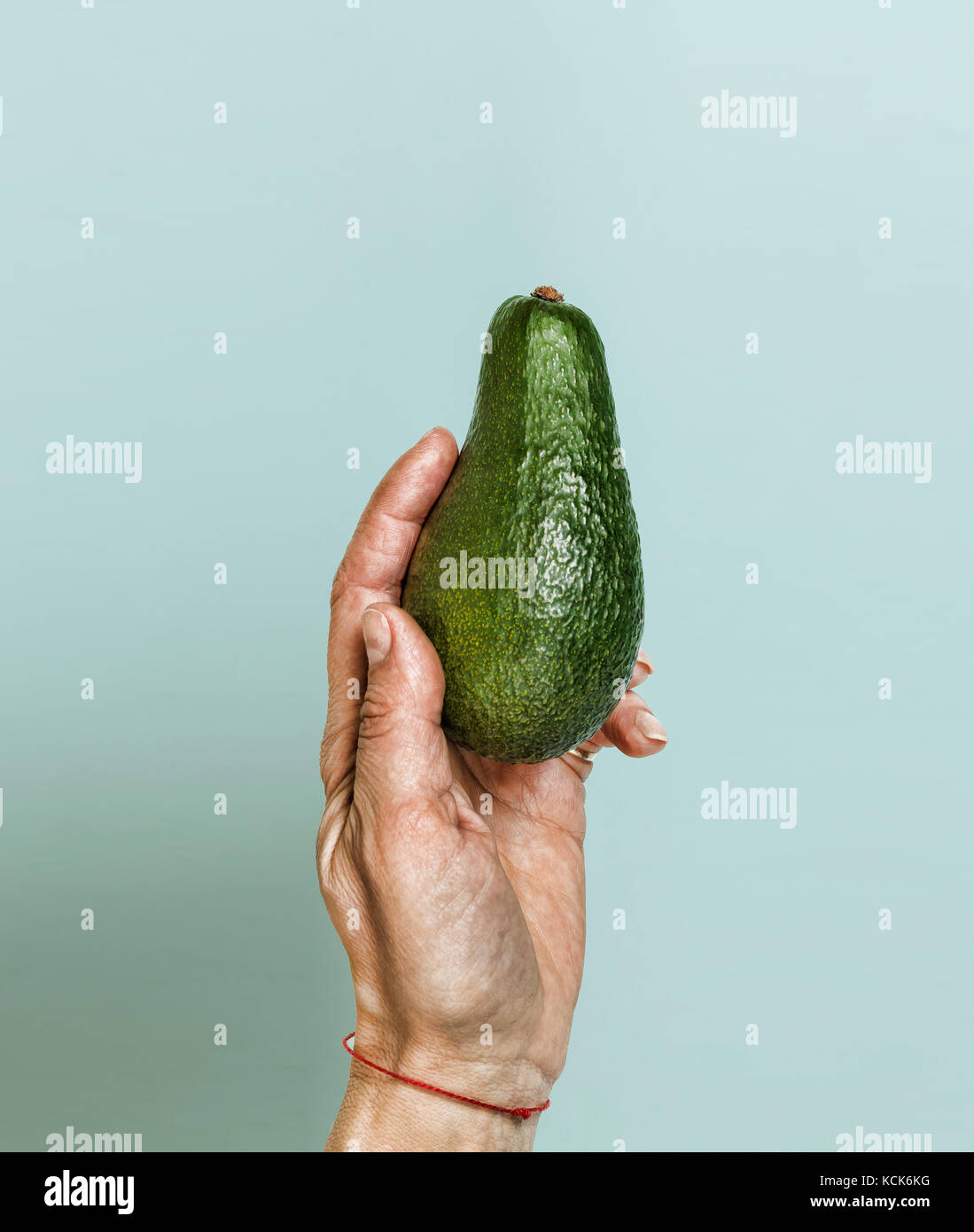 Style minimalism. Ripe avocado in a woman's hand Stock Photo - Alamy