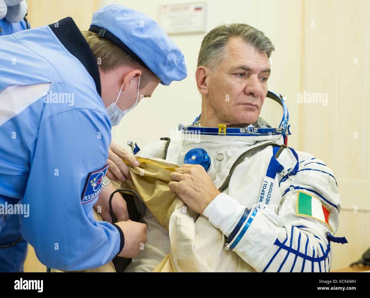 NASA International Space Station Expedition 52 prime crew member Italian astronaut Paolo Nespoli of the European Space Agency is helped into his Sokol spacesuit in preparation for the Soyuz MS-05 launch at the Baikonur Cosmodrome July 28, 2017 in Baikonur, Kazakhstan.  (photo by Andrey Shelepin  via Planetpix) Stock Photo