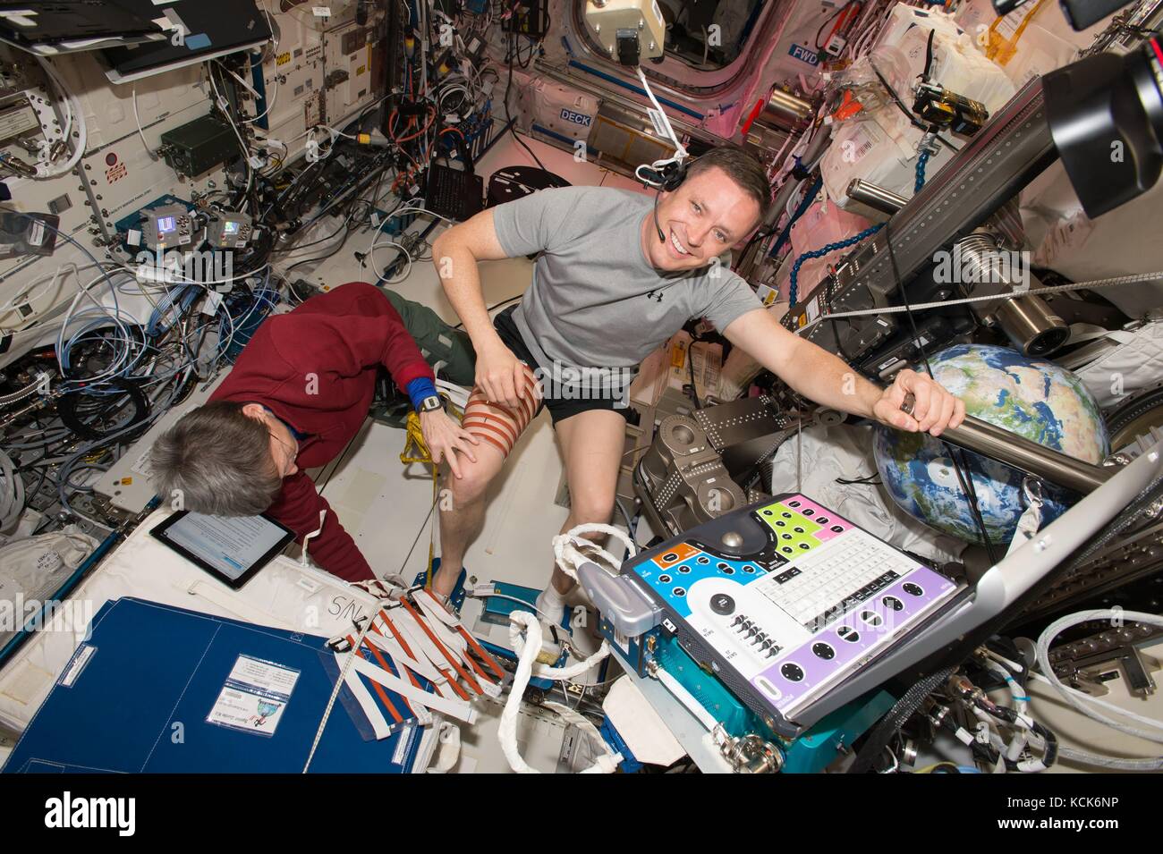 NASA International Space Station Expedition 51 prime crew members American astronauts Peggy Whitson (left) and Jack Fischer prepare for the Integrated Resistance and Aerobic Training Study experiment in the Columbus European Laboratory module May 3, 2017 in Earth orbit.  (photo by NASA Photo  via Planetpix) Stock Photo
