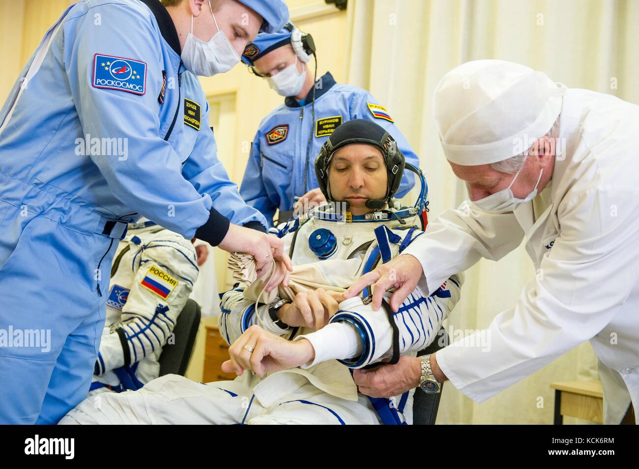 NASA International Space Station Expedition 52 prime crew member American astronaut Randy Bresnik is helped into his Sokol spacesuit in preparation for the Soyuz MS-05 launch at the Baikonur Cosmodrome July 28, 2017 in Baikonur, Kazakhstan.  (photo by Andrey Shelepin  via Planetpix) Stock Photo