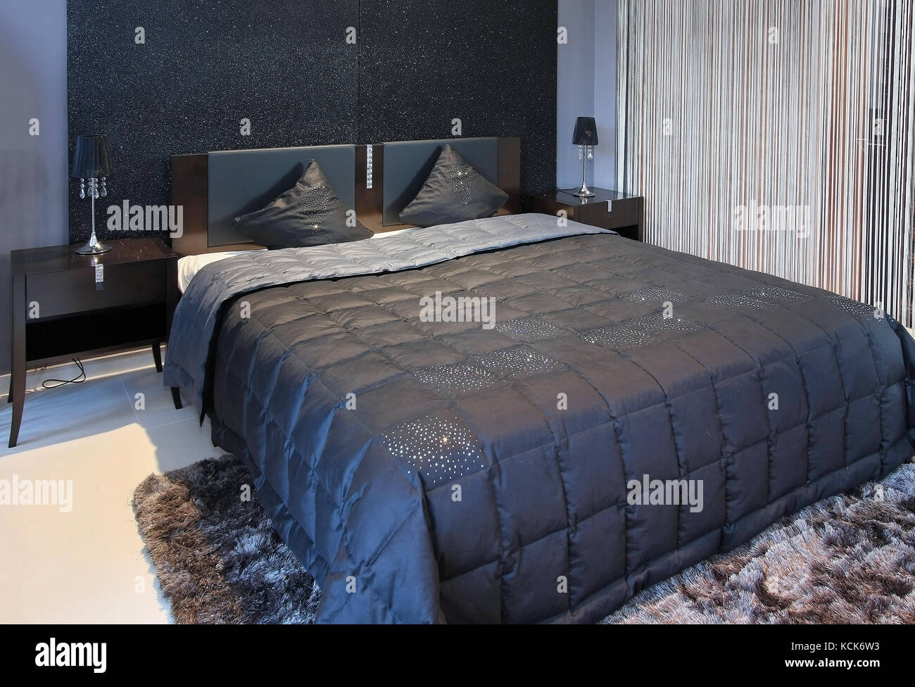 Modern bedroom interior with sparkling black wall and double bad ...