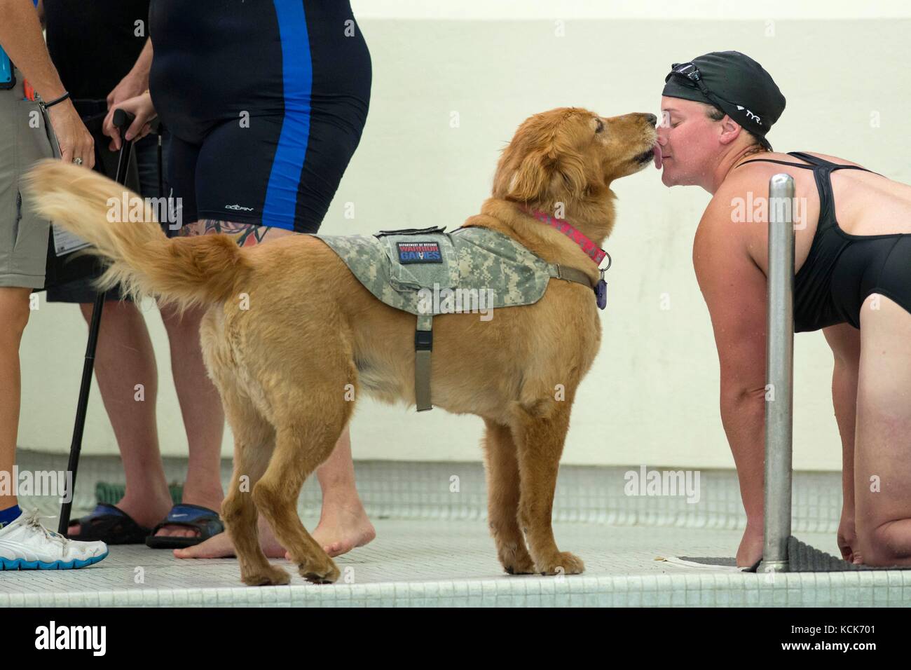 U.S. Army veteran Christina Gardner gets a kiss from her military service dog Moxie after competing in a swimming race during the Department of Defense Warrior Games at the University of Illinois July 8, 2017 in Chicago, Illinois. The DoD Warrior Games allow wounded, ill and injured soldiers and veterans to compete in Paralympic-style sports.  (photo by Roger L. Wollenberg  via Planetpix) Stock Photo