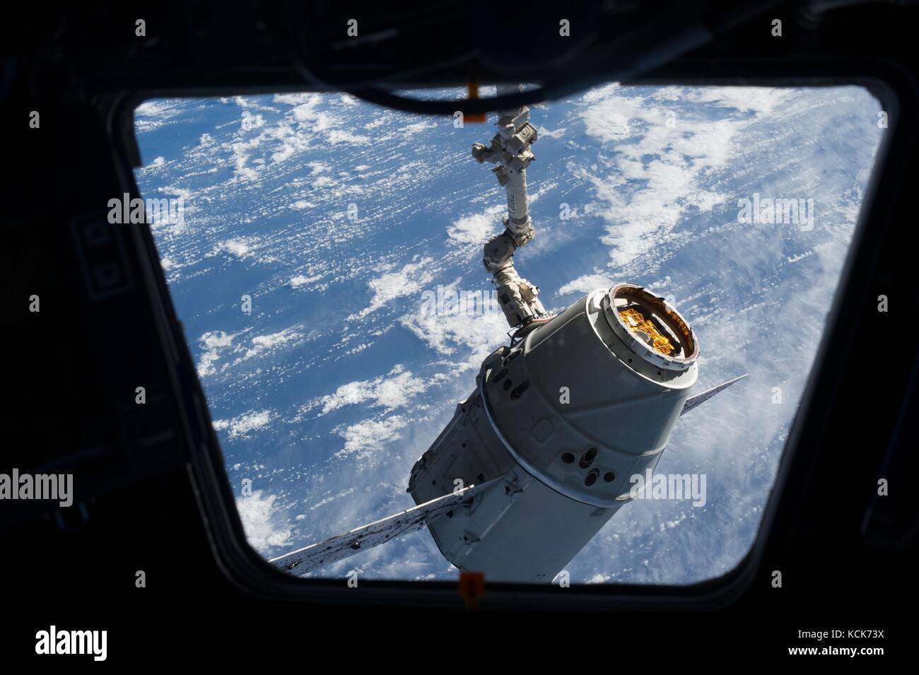 The NASA International Space Station Canadarm2 robotic arm captures the SpaceX Dragon 2 cargo spacecraft during a resupply mission March 3, 2013 in Earth orbit.  (photo by NASA Photo  via Planetpix) Stock Photo