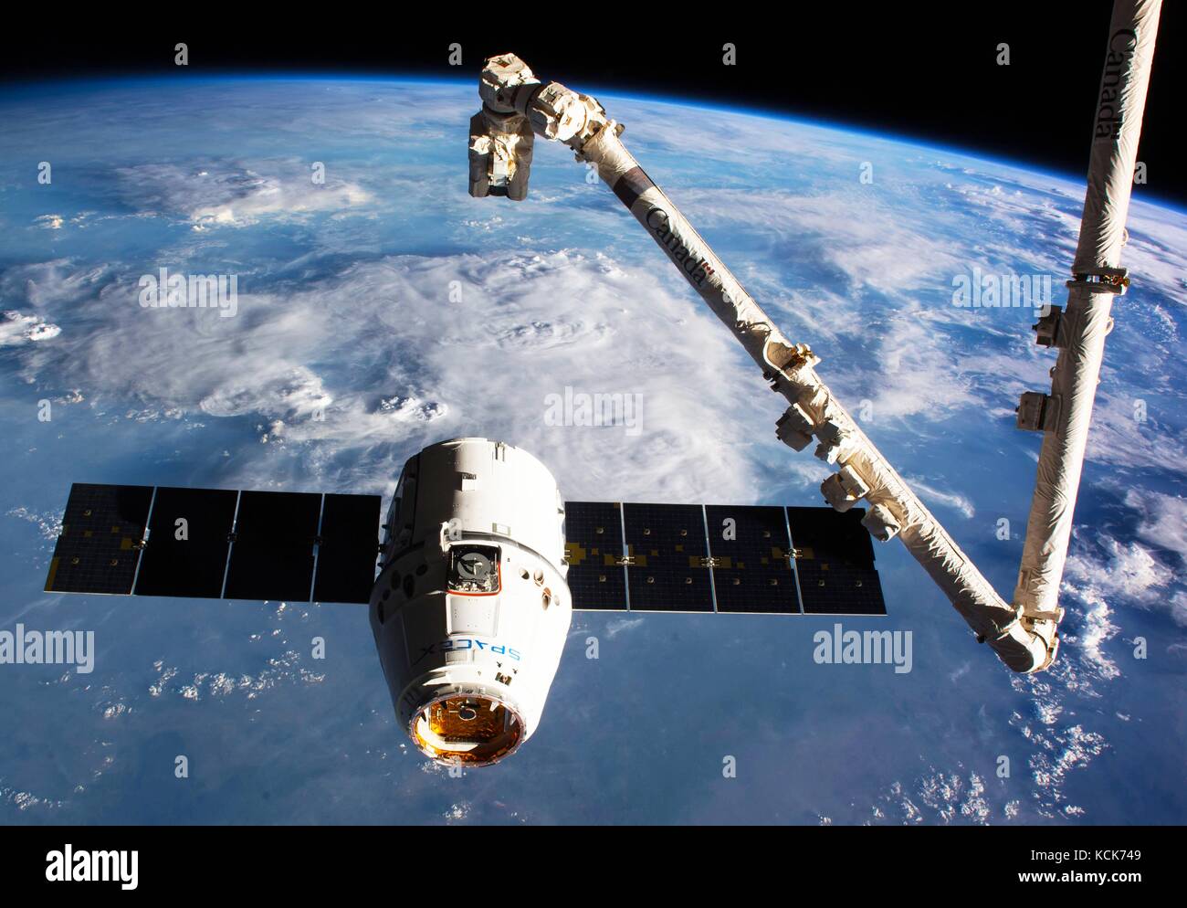 The NASA International Space Station Canadarm2 robotic arm prepares to grab the SpaceX CRS-10 Dragon cargo spacecraft as it approaches the ISS February 23, 2017 in Earth orbit.  (photo by NASA Photo  via Planetpix) Stock Photo